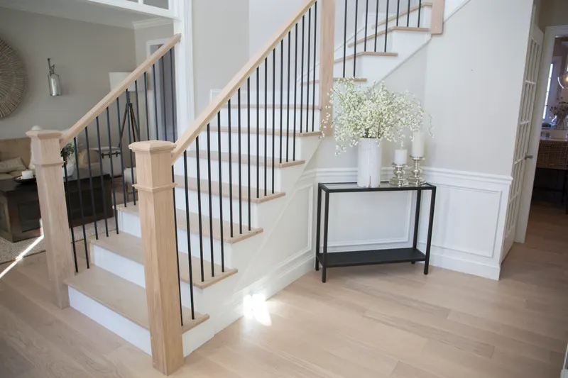 Modern staircase in light oak with black iron balusters