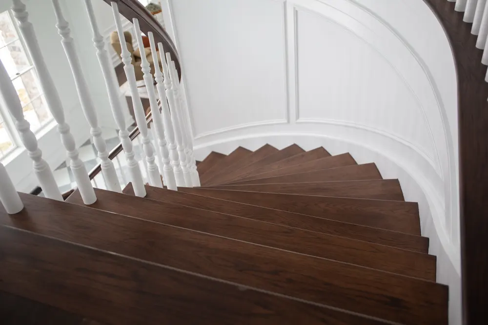 Curved walnut treads Snyder Stairs laminated in Whitehall for a Macungie home